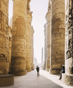 People walking in front of historical building