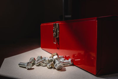 Close-up of red wine bottles on table against black background