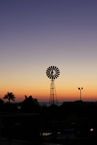 Silhouette of wind turbines at sunset