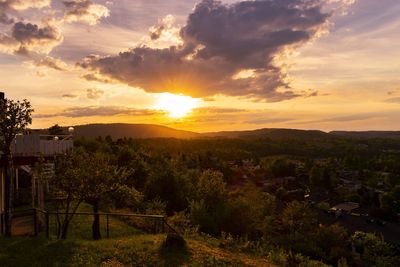 Scenic view of townscape against orange sky