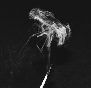 Close-up of smoke emitting from black background