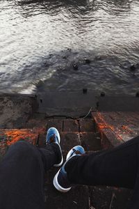 Low section of man standing in water