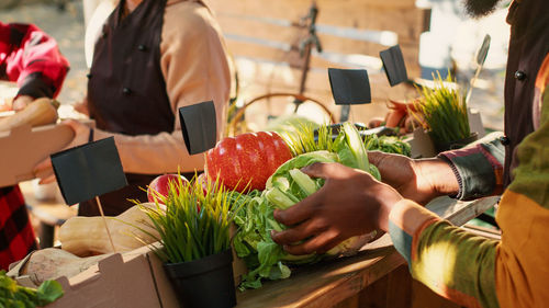 Midsection of woman preparing food at market