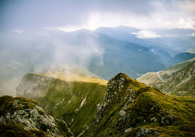 Scenic view of mountains against cloudy sky