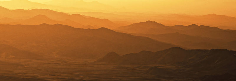 Scenic view of mountains against sky during sunset