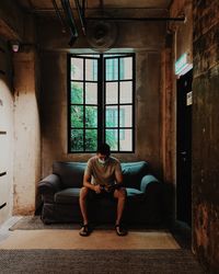 Man sitting in abandoned building