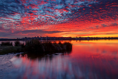 Scenic view of lake against romantic sky at sunset