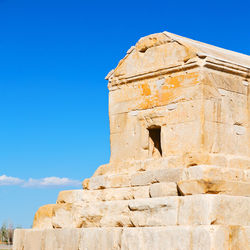 Low angle view of historical building against blue sky