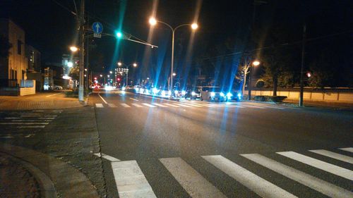 Illuminated city street at night