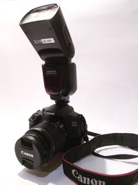 Close-up of camera over white background