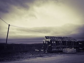 Old abandoned built structure on land against sky