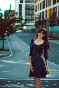 Young woman standing on street in city