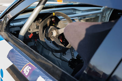 Exterior view from the driver's seat side of a grand touring racing car.