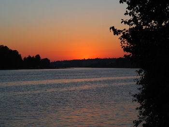 Scenic view of sea against orange sky
