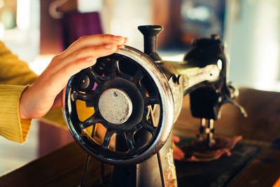 Close-up of women using sewing machine