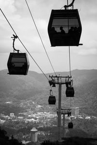 Low angle view of overhead cable car against sky