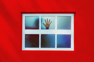 Close-up of hand on window