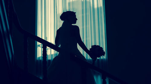 Silhouette of woman in window