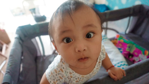 Close-up of cute baby girl at home