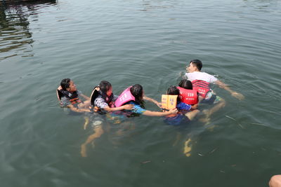 High angle view of people enjoying in water