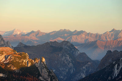 Scenic view of snowcapped mountains against sky during sunset