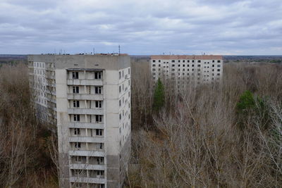 Buildings on field against sky