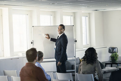 Group of business people attending presentation during conference