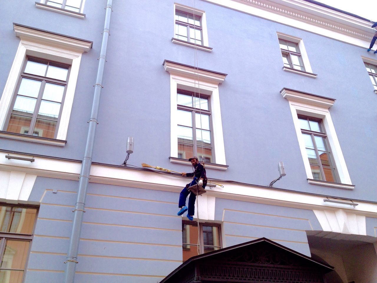 LOW ANGLE VIEW OF MAN WORKING AT WINDOW