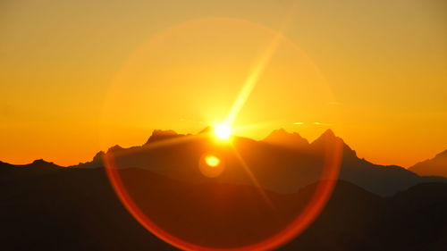 Scenic view of silhouette mountains against sky during sunset