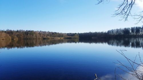 Scenic view of lake against clear blue sky