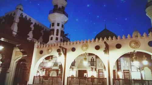 Low angle view of illuminated cathedral against sky at night