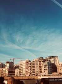 Low angle view of buildings against cloudy sky