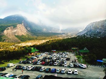 High angle view of cars at parking lot against mountains