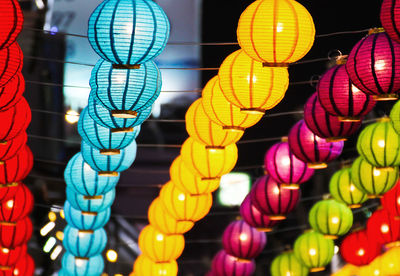 Low angle view of illuminated lanterns hanging at night