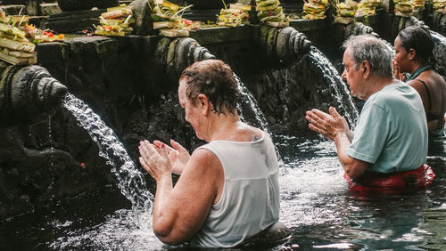 People enjoying in water fountain