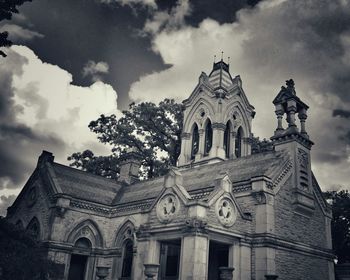 Low angle view of historical building against cloudy sky