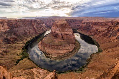 Rock formation and meander of a river against  sunset  and thunderstorm 