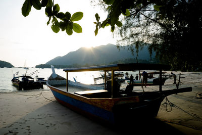 Boats moored in lake against sky