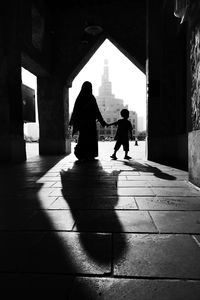 Rear view of silhouette people walking in building