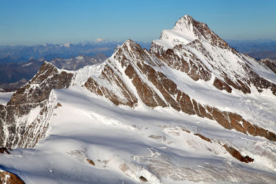 Low angle view of snowcapped mountains against sky