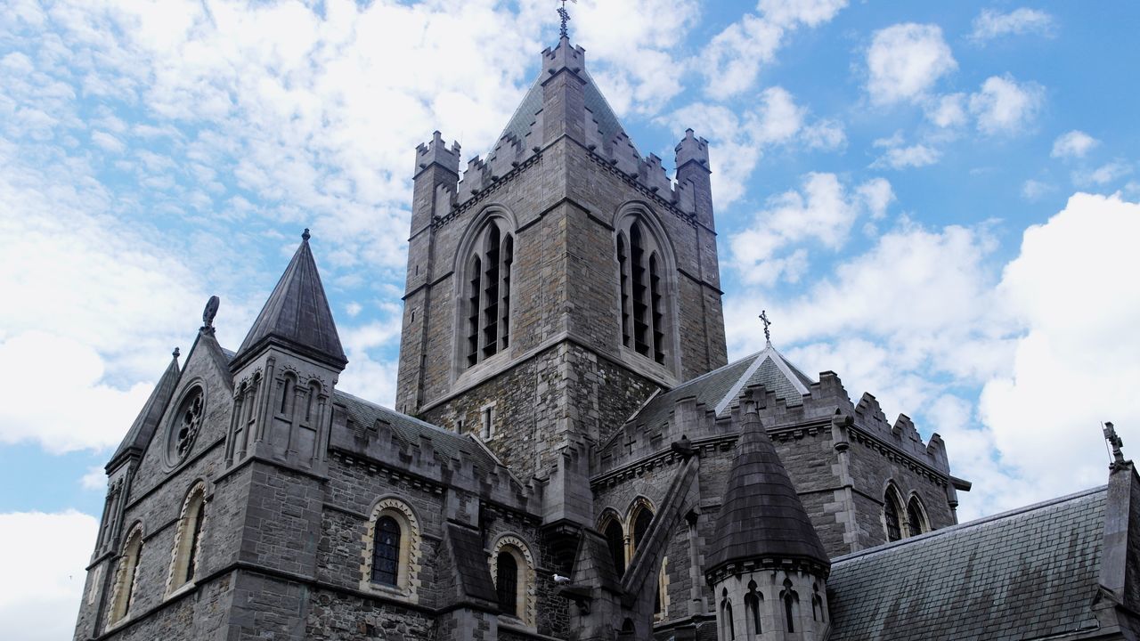 religion, place of worship, architecture, building exterior, church, spirituality, built structure, sky, low angle view, cathedral, cloud - sky, famous place, tower, clock tower, travel destinations, cross, cloud, history