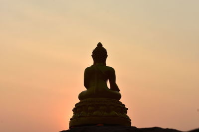 Low angle view of statue against sky during sunset