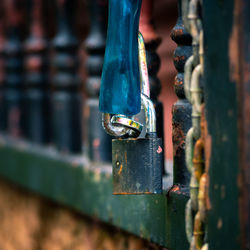 Padlock and chain on old fence