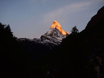 Low angle view of rock formation against sky during sunset