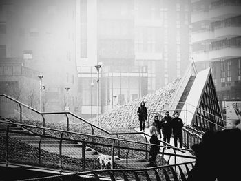 People in city against sky