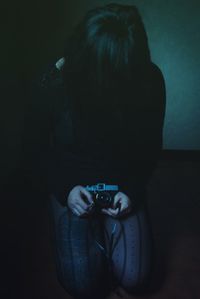 Rear view of woman photographing