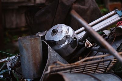 Close-up of rusty machine part on field