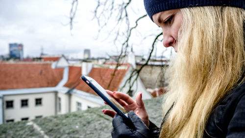 Portrait of woman using mobile phone outdoors