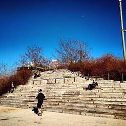 Silhouette of woman walking against clear sky
