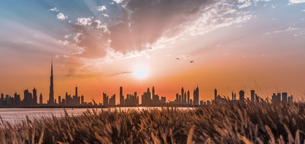 Panoramic view of buildings against sky during sunset